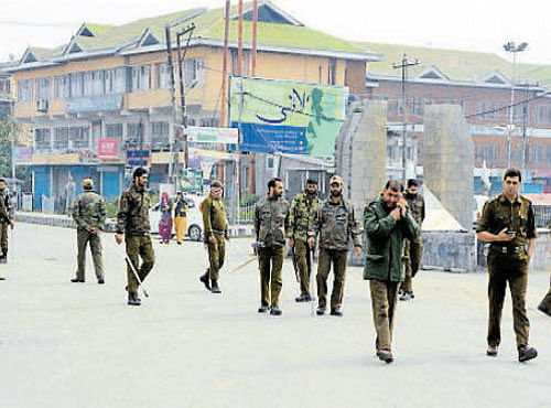 Security personnel patrol a street during curfew-like-restrictions imposed following protests, in Srinagar on Sunday. PTI
