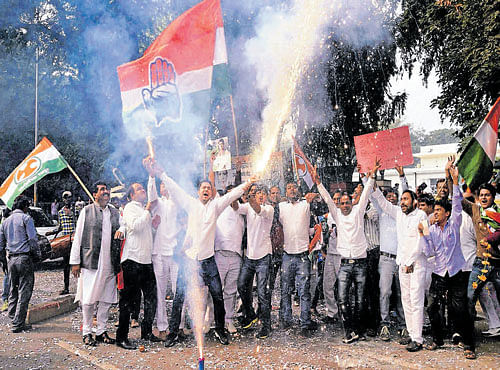 Congress supporters celebrate Bihar poll results at party headquarters in NewDelhi on Sunday. PTI
