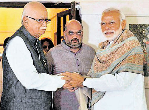 Prime Minister Narendra Modi greets senior BJP leader L K Advani on his 88th birthday in New Delhi on Sunday. BJP president Amit Shah looks on. PTI