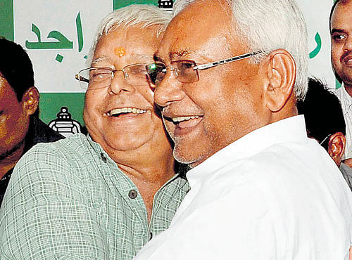 Bihar Chief Minister Nitish Kumar and RJD chief Lalu Prasad hug each other after the Grand Alliance victory in Bihar assembly elections at RJD office in Patna on Sunday. PTI