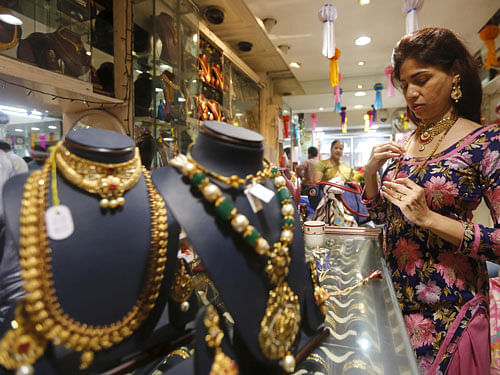 A customer tries a gold necklace at a jewellery showroom on the occasion of Dhanteras, a Hindu festival associated with Lakshmi, the goddess of wealth, at a market in Mumbai. Reuters Photo