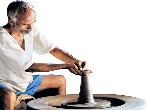 ARTIST'S TOUCHApotter operates on the potter'swheel in Kothali village in Belagavi district; attractivediyas available in the market.