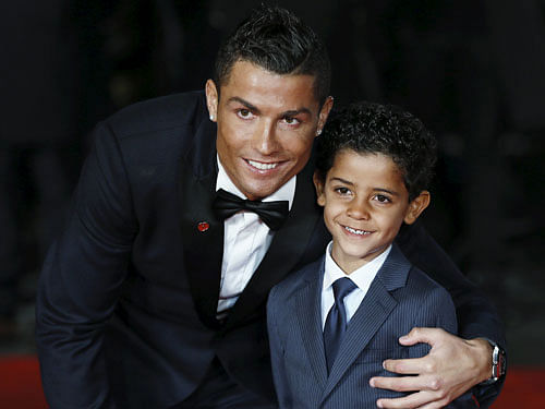 Soccer player Ronaldo and his son Ronaldo Jr. pose for photographers on the red carpet at the world premiere of 'Ronaldo' at Leicester Square in London. Reuters