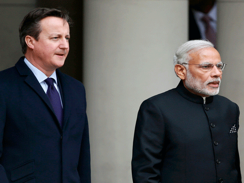 India's Prime Minister Narendra Modi's arrives with Britain's Prime Minister David Cameron for Modi's ceremonial welcome during his official visit, in London. reuters photo