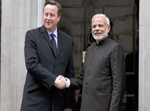 Prime Minister Narendra Modi and his UK counterpart shake hands before a delegation level meeting at 10 Downing Street in London on Thursday. PTI Photo