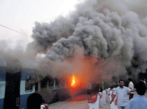 ON FIRE: Smoke billowing out of a coach after three express trains caught fire at Puri Station on Thursday. PTI