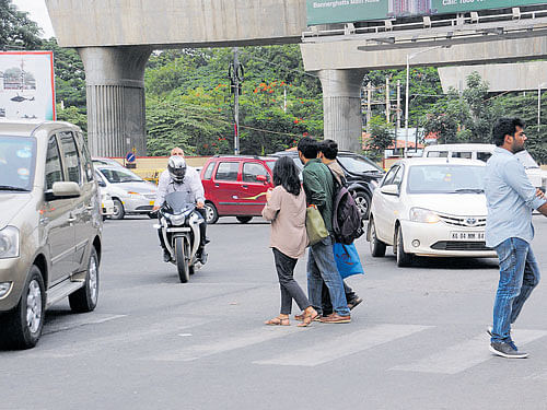 The police will book cases against people who indulge in jaywalking, unsafe road-crossing and riding on footpaths.DH Photo