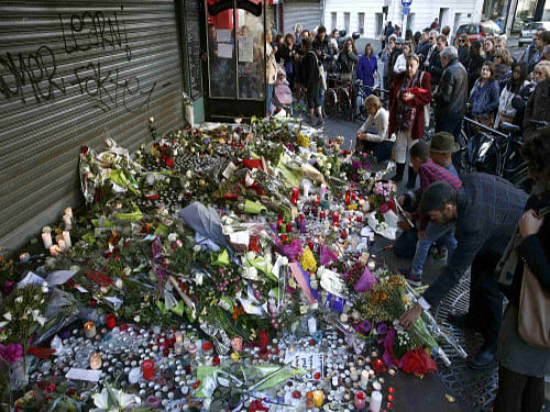 People pay their respect at one of the attack sites in Paris. Reuters photo