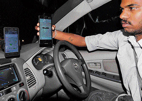 An Uber driver shows the mobile apps of the driver and the traveller inside his vehicle. DH Photos:&#8200;B H Shivakumar