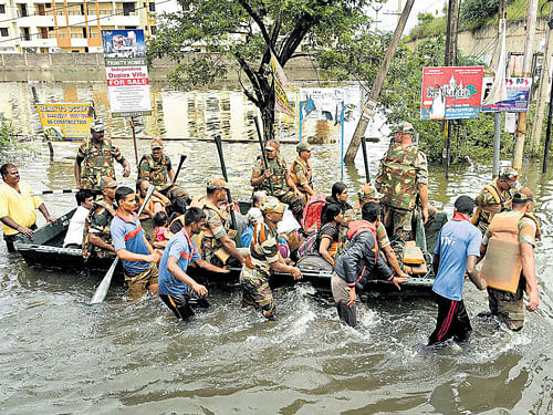 Rain Fury: (1) Army personnel rescue people during flood relief operations in rain-hit areas of Chennai on Tuesday. PTI Photo