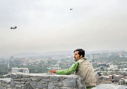 Helicopters ferry employees working with the US to and from offices as a security blimp keeps watch in Kabul. Since the end of the UN combat mission, many restaurants have closed, news organisations have packed up, leaving the city empty of foreigners. nyt