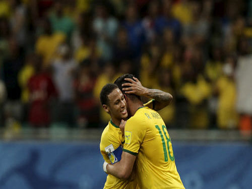 Brazil's Renato Augusto celebrates with teammate Neymar after scoring against Peru. Reuters