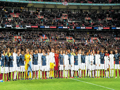 England and France players line up ahead of their friendly tie at the Wembley stadium on Tuesday. Reuters