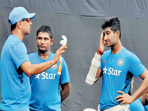 play straight... Indian U-19 coach Rahul Dravid (left) has a word with his players during a training session ahead of the tri-series against Bangladesh and Afghanistan in Kolkata. pti