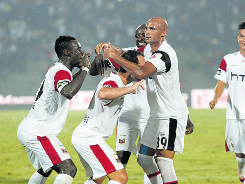 Let's party! NorthEast United's Diomansy Kamara (centre) celebrates with team-mates after scoring against Mumbai.