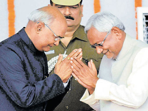 Nitish Kumar greets Governor Ram Nath Kovind after taking oath as the Chief Minister of Bihar during the swearing-in ceremony at Gandhi Maidan in Patna on Friday. PTI