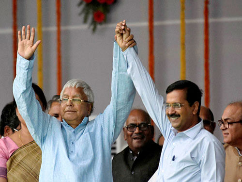 RJD Chief Lalu Prasad with Delhi Chief Minster Arvind Kejriwal during the swearing-in ceremony of the new Bihar government at Gandhi Maidan in Patna on Friday. PTI Photo