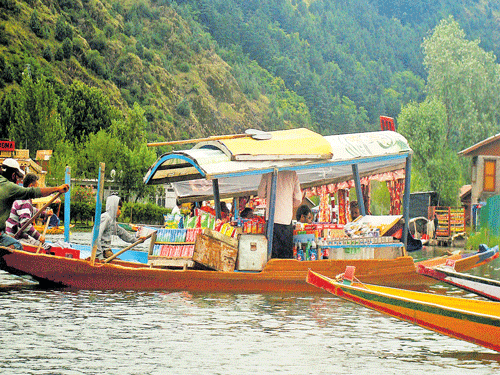 A trader sells various products in shikara in Dal Lake in Srinagar.