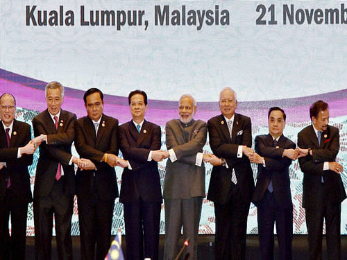 Prime Minister Narendra Modi join hands with other leaders during a group photo at the 13th ASEAN-India Summit in Kuala Lumpur, pti file photo