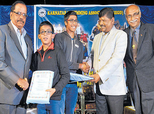 DESERVING (From left) Gopal Hosur, fromer IPS officer, felicitates Karnataka swimmer Sohan Ganguly, while M Kempaiah, former IPS officer, honours Sanjay CJ for their achievements this season during a function by the Karnataka Swimming Association on Sunday. Neelakanta Rao R Jagdale, president of the KSA, is also seen. DH PHOTO