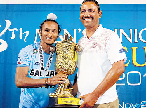 MOMENT TO SAVOUR India junior teamcoach Harendra Singh (right) and captain Harjeet Singh with the Asia Cup trophy.