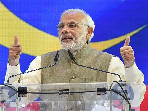 Prime Minister Narendra Modi addresses people from Indian community during an event in Kuala Lumpur, Malaysia on Sunday . PTI Photo