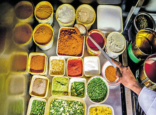 SPICE IT UP:A chef with curry ingredients at Cafe Saffron in Shrewsbury, Shropshire county, England. Britain is facing a growing shortage of curry chefs due to tighter restrictions on immigration and retirement of the first generation of those who opened restaurants in 1960s. NYT