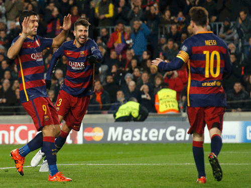 Barcelona's Gerard Pique celebrates scoring the fourth goal with Lionel Messi and Luis Suarez. Reuters Photo.