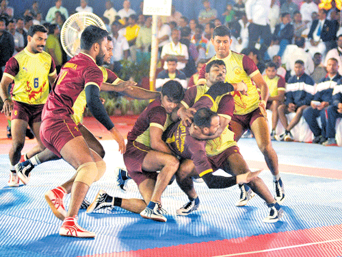 no way out Karnataka players trap West Bengal raider Shyam Kr Sah (third from right) during their league match of the 63rd Senior National kabaddi championship at the Malleswaram grounds in Bengaluru on Wednesday.  DH Photo/ Srikanta Sharma R