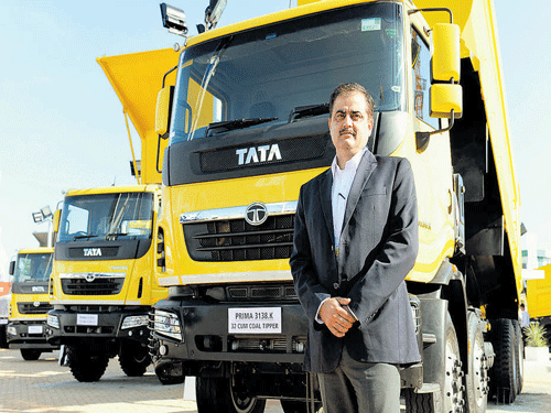 Rajesh Kaul poses with TATA's truck range at EXCON 2015, in Bengaluru on Wednesday. DH&#8200;photo by b h shivakumar