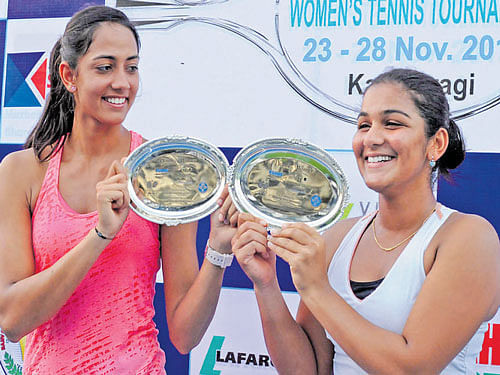 ALL SMILES Karman Kaur (left) and Druthi Venugopal with the doubles spoils. DH PHOTO/ KRISHNAKUMAR PS