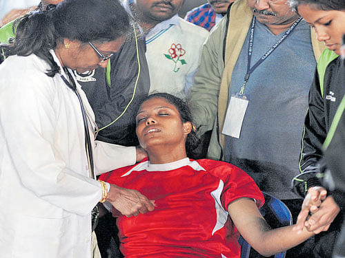 Assam's Bhanita Bora is being treated by a doctor after she collapsed during the game against BAKA on&#8200;Friday. DH photo/ srikanta sharma r
