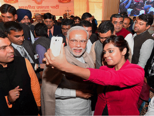 Prime Minister Narendra Modi poses for a selfie with reporters during the Diwali Mangal Milan at BJP headquarters in New Delhi on Saturday. PTI Photo