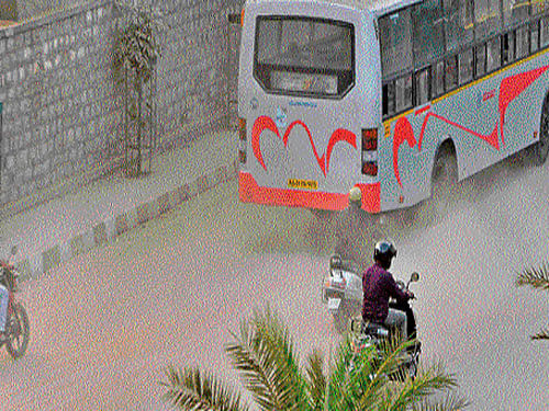 Two-wheeler riders caught in a storm of dust near Sankey Tank in the City. dh file photo
