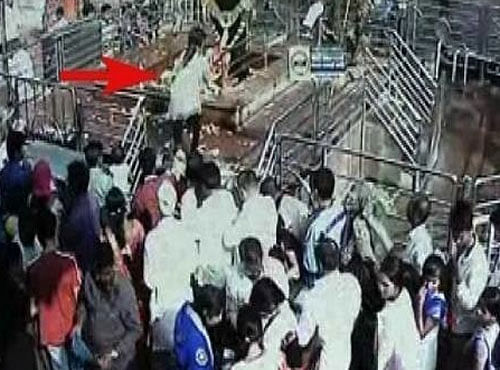 The woman climbed the security barricade to the 'chauthara' (platform) where the idol is installed and offered prayers yesterday, before disappearing in the crowd. Picture courtesy Twitter