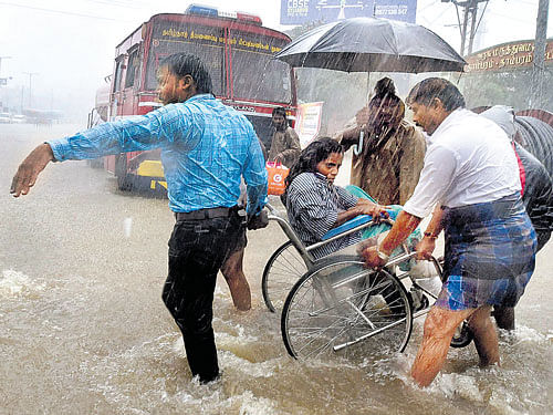 Testing times: Patients being shifted from a flooded hospital after heavy rain in Chennai on Tuesday. PTI