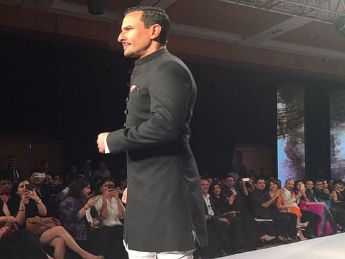 Saif Ali Khan turned heads as he hit the fashion runway in a black achkan with fitted bottoms. Image courtesy: twitter