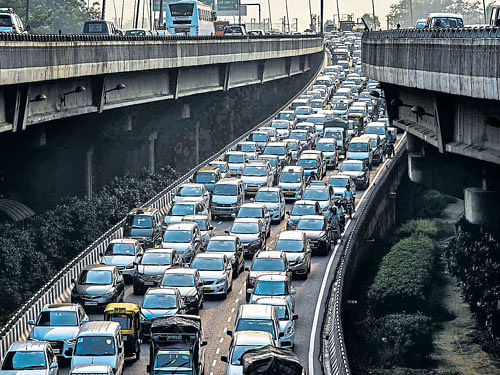 serpentine course: A stream of cars backs up on a highway exit in New Delhi. Emerging markets like India are demanding "carbon space" from the rich world to allow poorer economies to burn their way to development. nyt