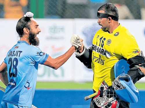Jasjit Singh (left) and goalkeeperPRSreejesh celebrate India's quarterfinal win over Britain on Thursday.