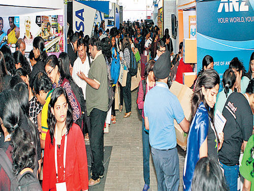 Participants gather details at stalls in the Student Career Fair organised exclusively for women from computing, IT and engineering backgrounds, in Bengaluru on Tuesday.