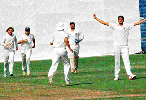 Maharashtra bowler Nikit Dhumal (right) celebrates the fall of a Karnataka batsman on the final day of their Group A Ranji Trophy encounter in Pune on Friday. dh photo