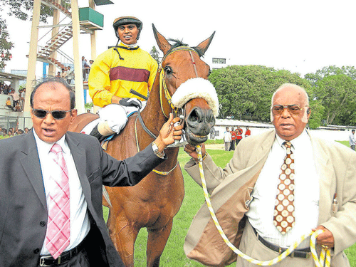 great partnership Owner Dr MAM Ramaswamy (right) and trainer S Ganapathy lead in Bourbon King (Prakash astride) after winning the 2007 Kingfisher Bangalore Derby. dh file photo