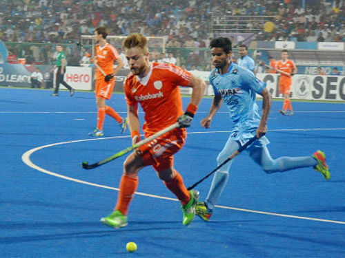 Players of India and Netherlands vie for the ball at the FIH Hockey World League Final in Raipur on Sunday. PTI Photo