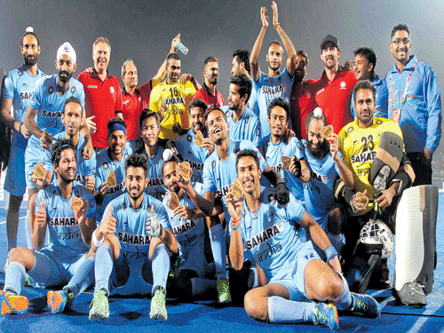heroic performance: A jubilant Indian team show off their bronze medals after defeating the Netherlands via tie-breaker in Raipur on Sunday.
