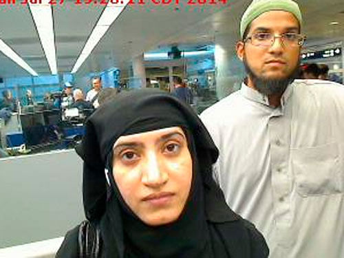 Tashfeen Malik and Syed Farook are pictured passing through Chicago's O'Hare International Airport in this July 27, 2014 handout photo. reuters