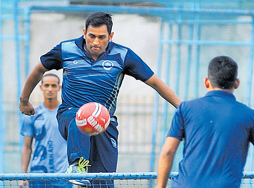 BACK IN ACTION:Mahendra Singh Dhoni indulges in a game of football at the Chinnaswamy Stadium on Tuesday. Dhoni will play for Jharkhand in the Vijay Hazare Trophy. DH PHOTO