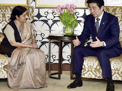 Japanese Prime Minister Shinzo Abe talks with Foreign Minister Sushma Swaraj, in New Delhi on Friday. PTI Photo