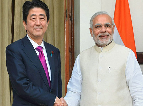 Prime Minister Narendra Modi shakes hands with his Japanese counterpart Shinzo Abe before their meeting, in New Delhi on Saturday. PTI Photo