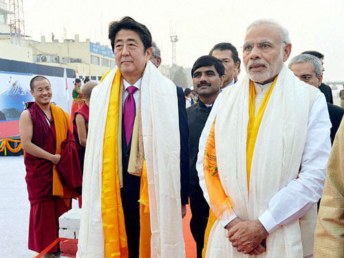 Prime Minister Narendra Modi and the Prime Minister of Japan, Shinzo Abe being given traditional welcome on their arrival in Varanasi, Uttar Pradesh on Saturday. PTI Photo