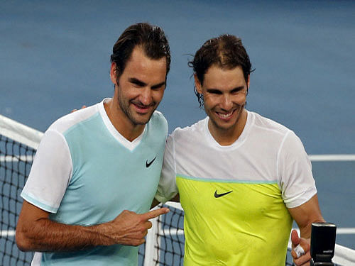Spain's Rafael Nadal of the Indian Aces (R) and Switzerland's Roger Federer of the Japan Warriors greet each other during practice at the International Premier Tennis League (IPTL) event in New Delhi on Saturday. Reuters